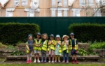 Kids wearing hard hat and standing at a construction site