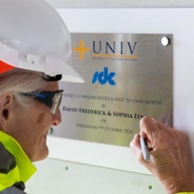 Sophia Lynn signing a plaque at the Univ North site, October 2024