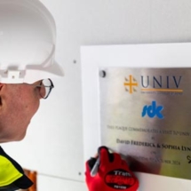 David Frederick signing a plaque at the Univ North site, October 2024